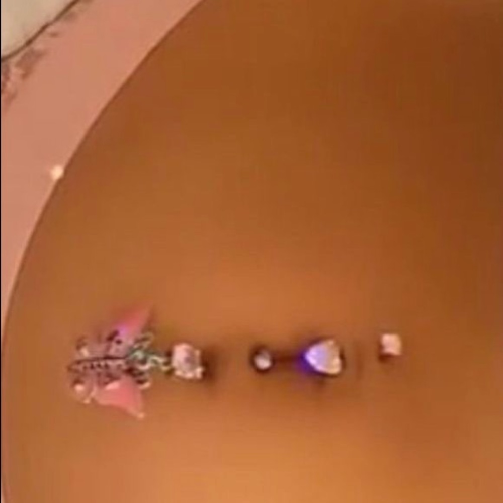 Pink butterfly belly piercing